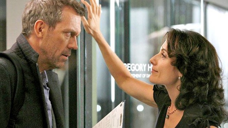 Hugh Laurie as Gregory House and Lisa Edelstein as Lisa Cuddy flirt in the office in House