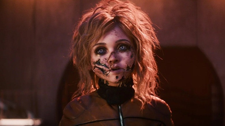 M3GAN with messed up hair and her face blown to bits in M3GAN 2.0