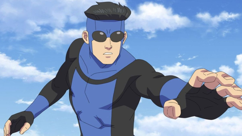 Mark Grayson put on his blue and black invincible costume, holding his hand