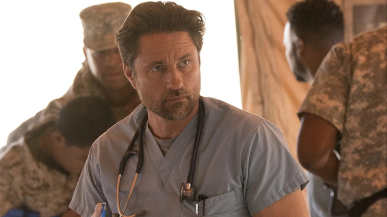 Nathan in scrubs on a military base in Grey's Anatomy