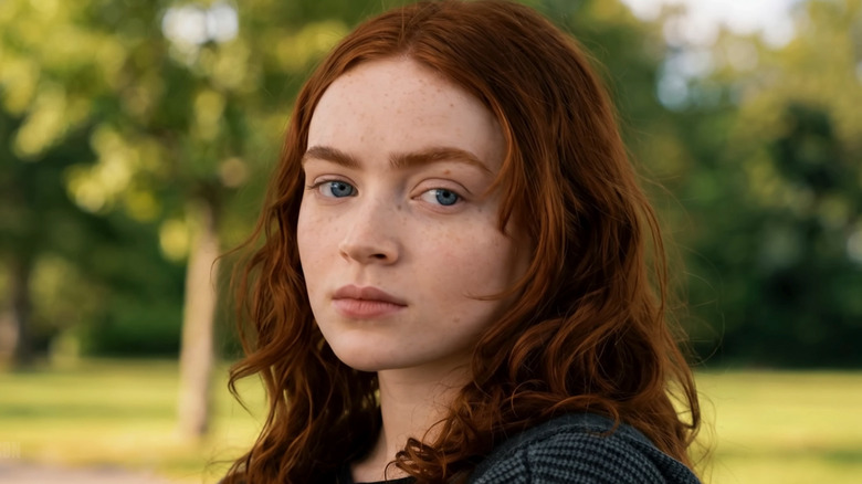 Sadie Sink's Jean Grey is seen in closeup as she sits in a park in Spider-Man Brand New Day