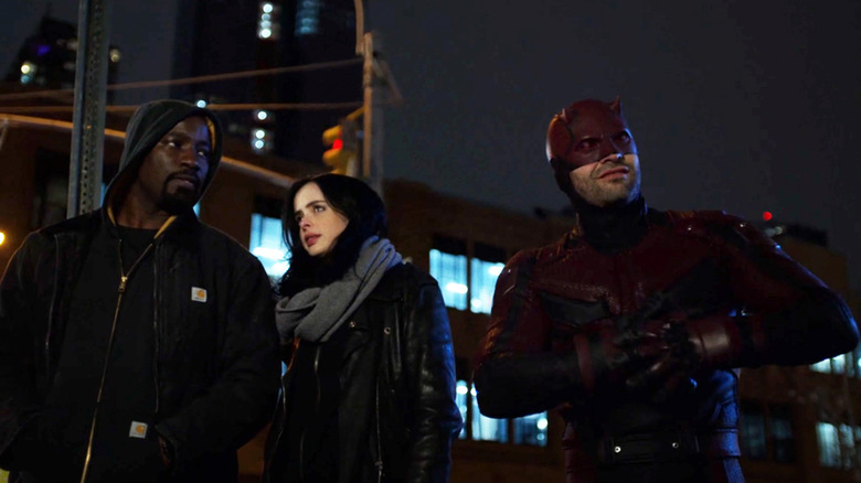Mike Colter's Luke Cage stands next to Krysten Ritter's Jessica Jones and Charlie Cox's Daredevil in The Defenders