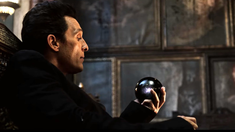 The black tower, the man in black playing with a crystal ball