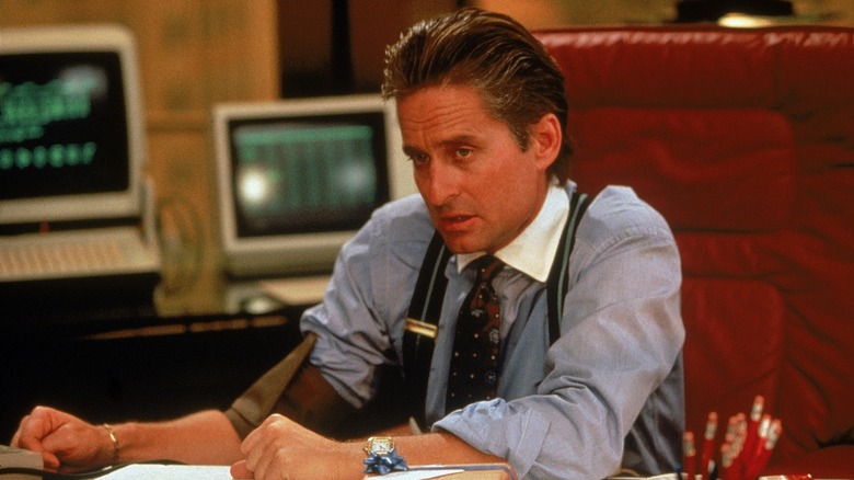 Michael Douglas sitting at desk Wall Street