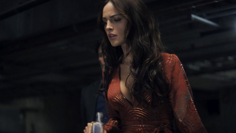 Alice looking down into a car trunk in Mike & Nick & Nick & Alice