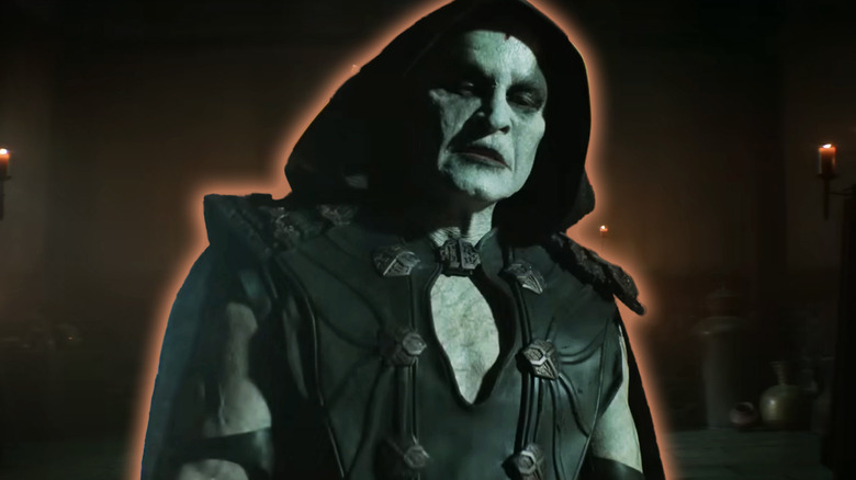 Damon Herriman as Quan Chi wearing a hood in Mortal Kombat II