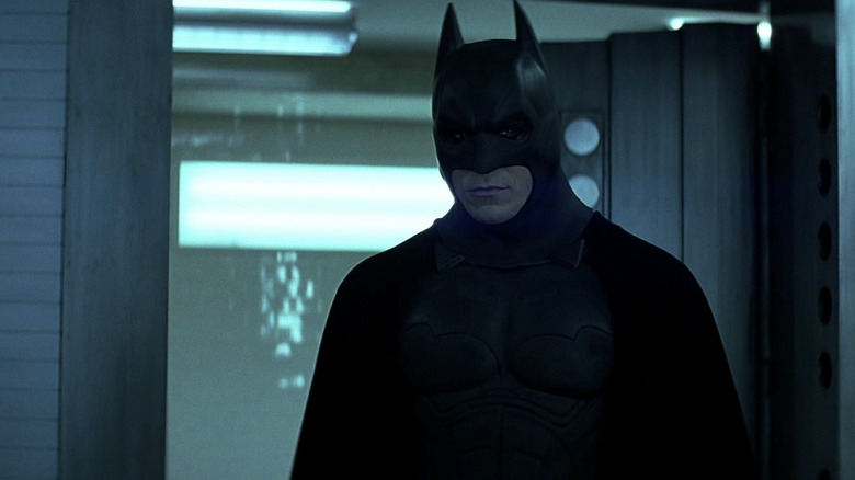 Christian Bale's Batman stands in a bank vault in The Dark Knight