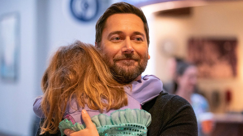 Dr. Max Goodwin hugging a child on New Amsterdam