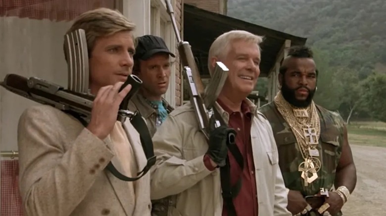 Dirk Benedict as Faceman, Dwight Schultz as Howling Mad Murdock, George Peppard as Hannibal Smith and Mr. T as B.A. Baracus are heavily armed in The A-Team