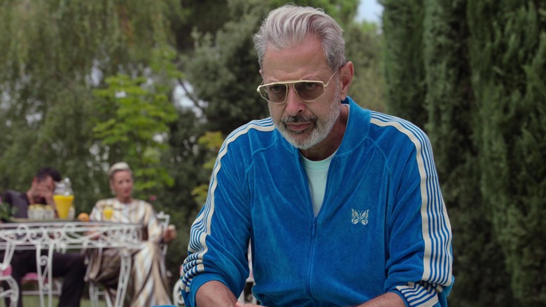 Jeff Goldblum as Zeus in a blue tacksuit in Kaos