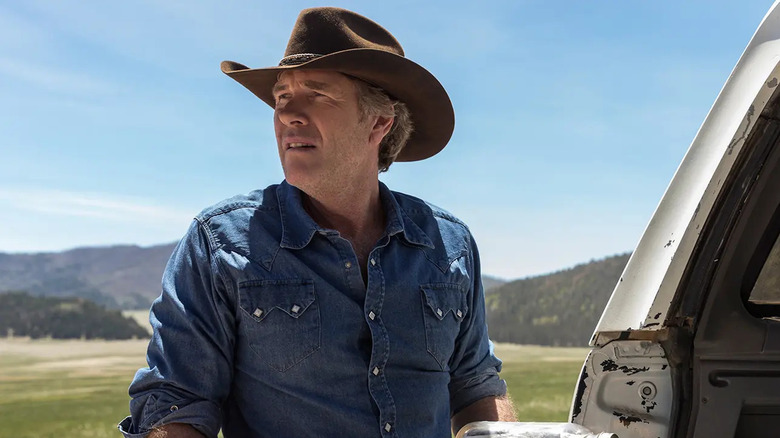 Walt holding a jar full of cash on Longmire