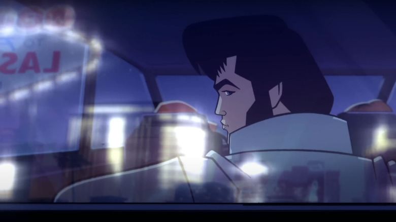 Elvis is seen from behind driving a car with a Las Vegas sign reflected in the window in Agent Elvis