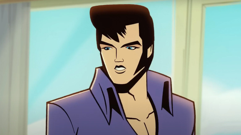 Elvis stands in front of a row of windows in Agent Elvis