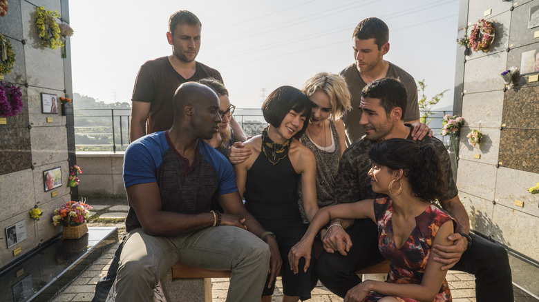 The Sensates sitting and standing together on a rooftop in Sense8