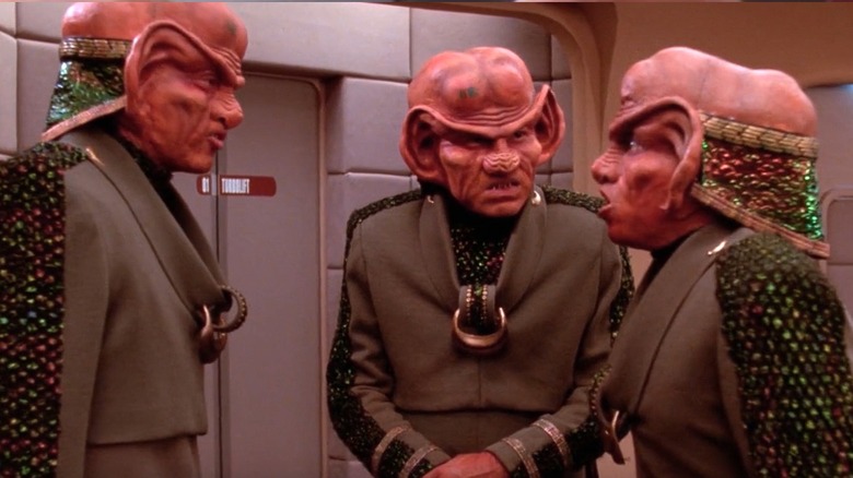 Quark holding a pile of gold-pressed latinum on Star Trek