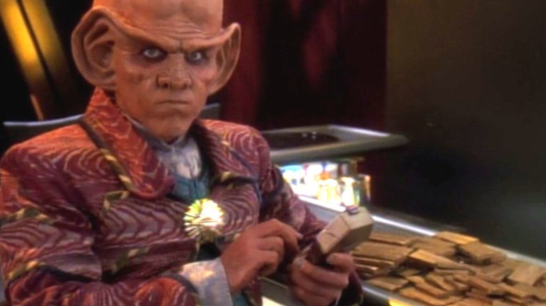 Quark next to a pile of gold-pressed latinum on Star Trek