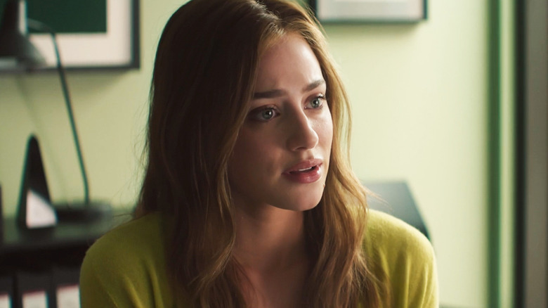 Lili Reinhart's Olive Smith is seen sitting in an office in The Love Hypothesis