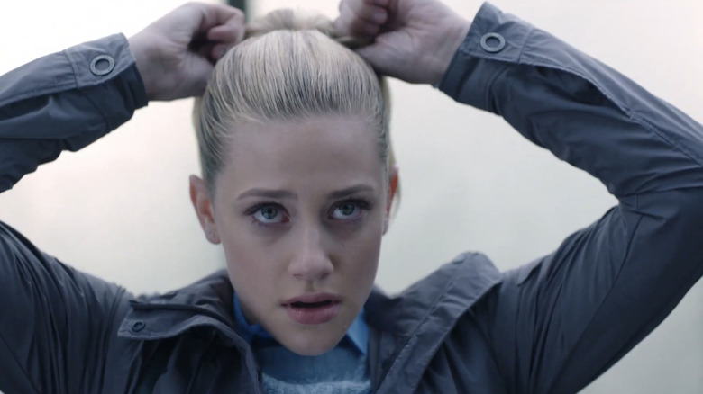 Lili Reinhart's Betty Cooper ties her ponytail in Riverdale