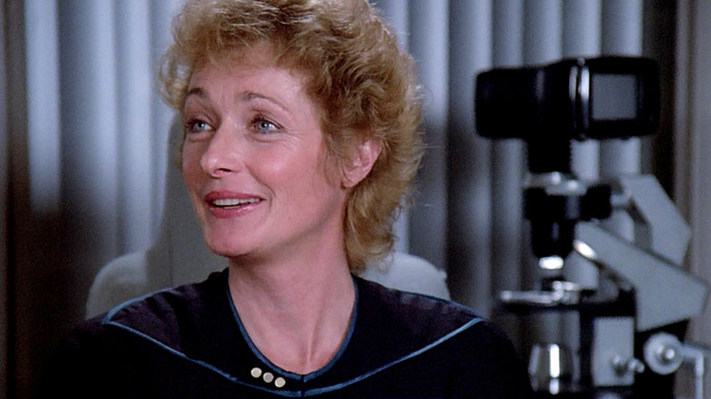 Dr. Pulaski smiling in her medical lab on Star Trek: The Next Generation