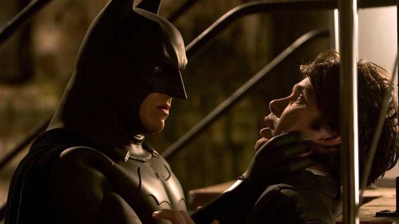 Batman holds the scarecrow through his face in Batman begins.