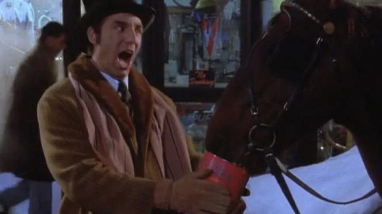 Kramer, singing to a horse outdoors while it eats a can of Beef-A-Reeno, a scene from Seinfeld.