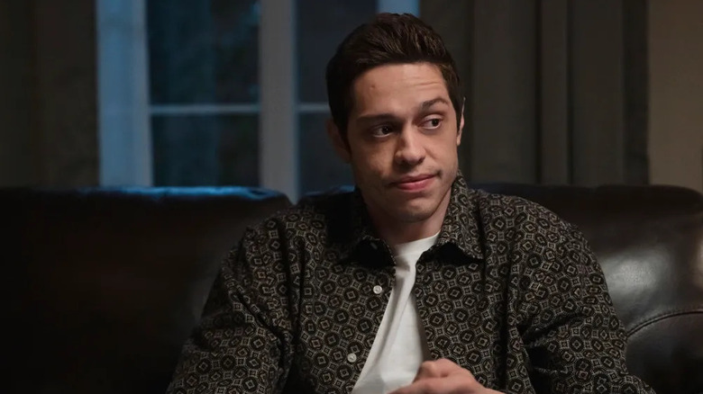 Pete Davidson thinking on a couch in Bupkis