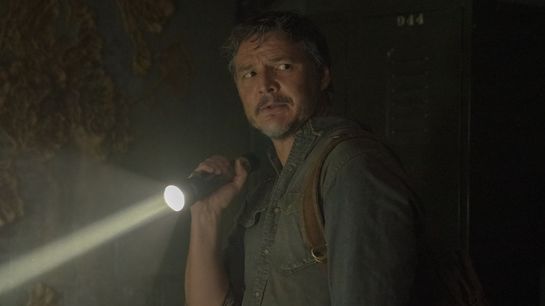 Pedro Pascal as Joel holding a flashlight in The Last of Us
