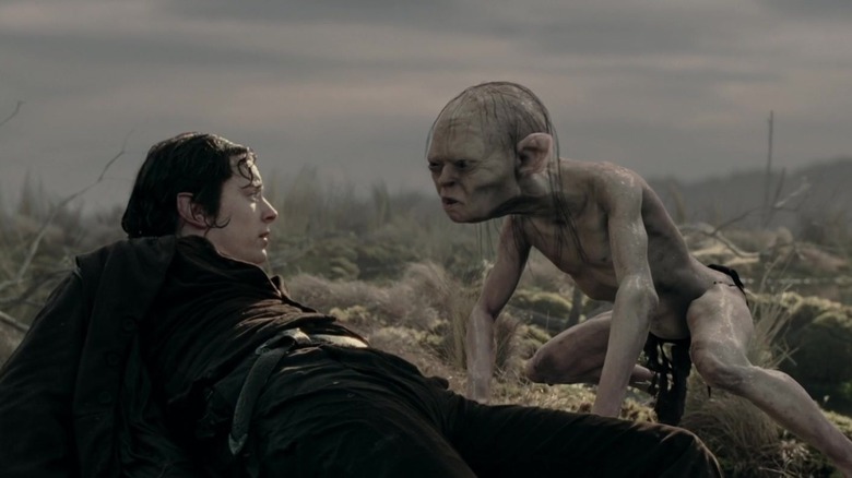 Gollum looking at Frodo after pulling him out of the water in The Lord of the Rings: The Two Towers