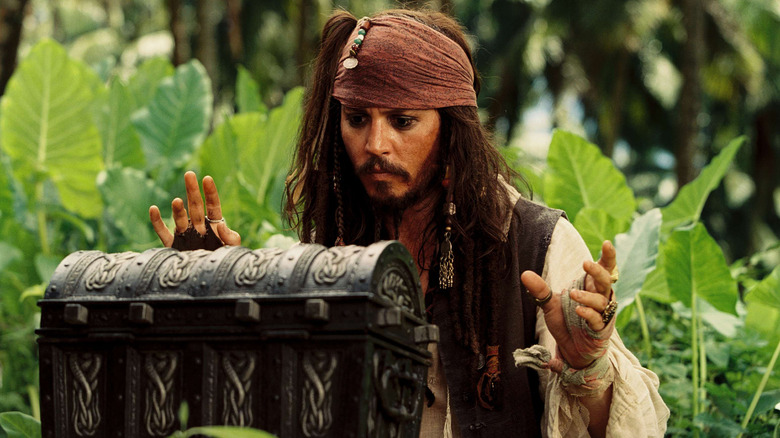 Johnny Depp as Jack Sparrow about to open a chest in Pirates of the Caribbean: Dead Man's Chest