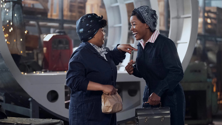 Chanté Adams as Maxine laughing inside a factory in A League of Their Own (2022)