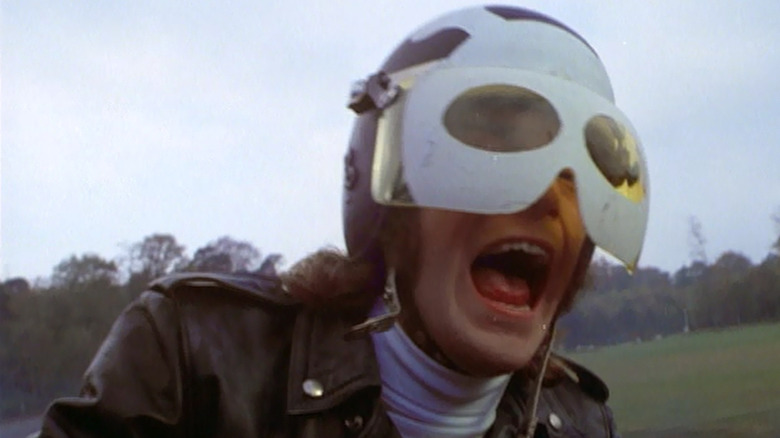 Tom Latham (Nicky Henson) screams on his motorcycle in Psychomania (1973)