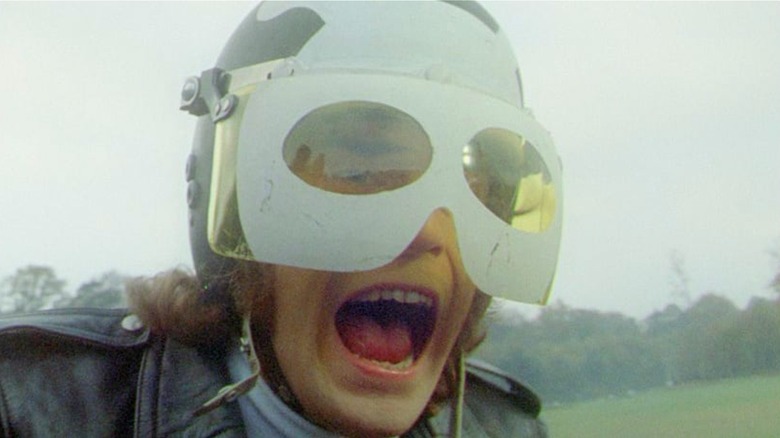Tom Latham (Nicky Henson) screams on his motorcycle in Psychomania (1973)