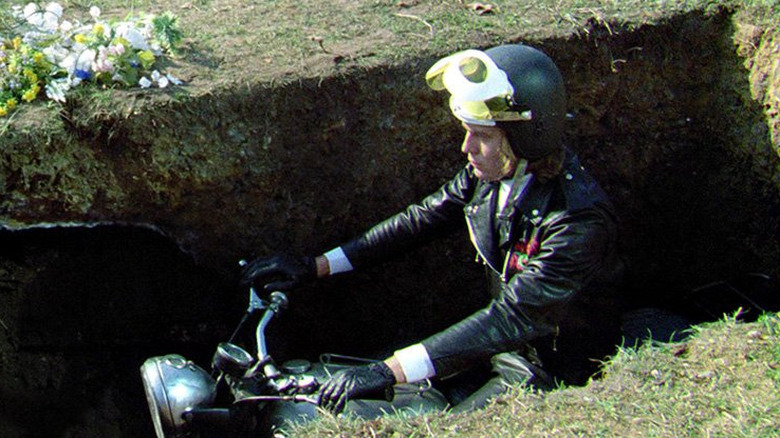 Tom Latham (Nicky Henson) is buried by friends in Psychomania (1973)