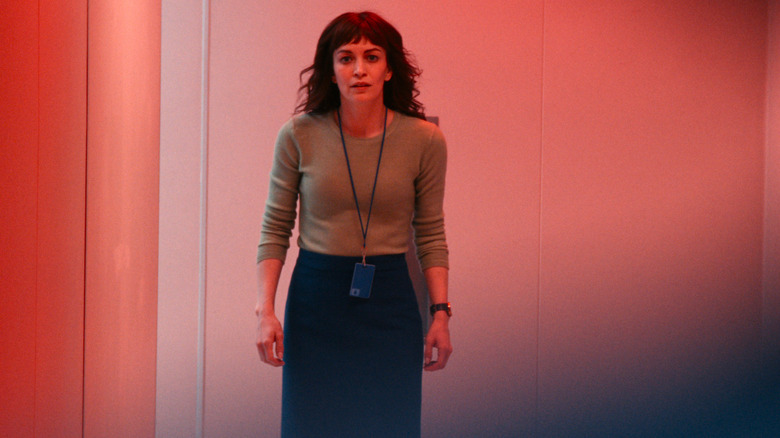 Helly looking hopeful while bathed in red light in Severance