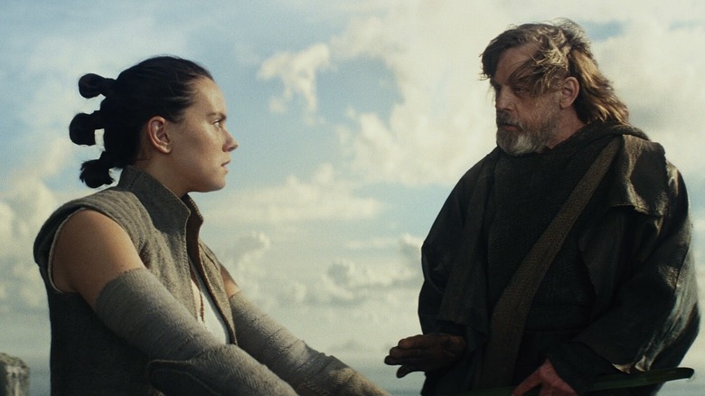Daisy Ridley as Rey being trained by Mark Hamill as Luke in Star Wars: The Last Jedi