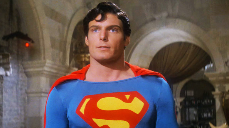 Christopher Reeve's Superman smiles as he stands in front of archways in Superman