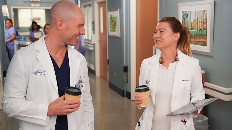 Cormac and Meredith smiling in the hallway on Grey's Anatomy