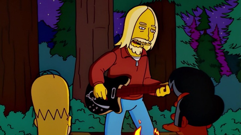 An animated Tom Petty with an electric guitar singing a campy rock song. Homer Simpson and Apu watch.