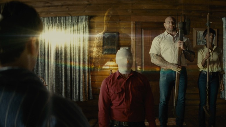Rupert Grint, Dave Bautista, and Nikki Amuka-Bird in Knock at the Cabin