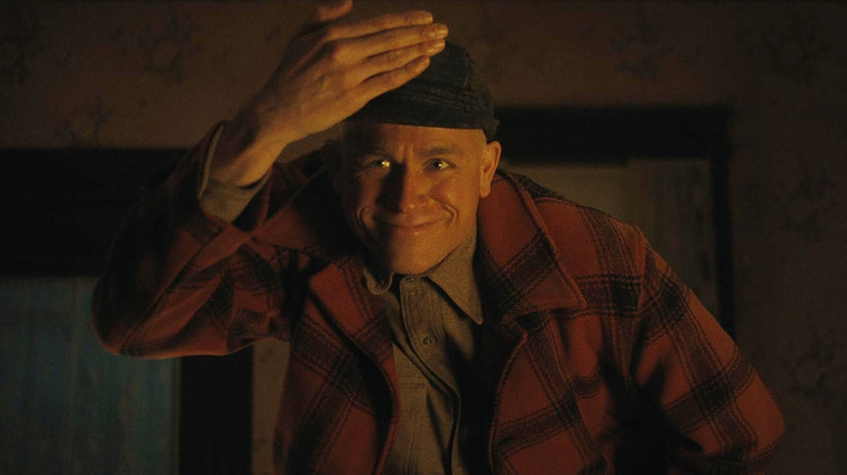 Charlie Hunnam as Ed Gein bowing in Monster: The Ed Gein Story