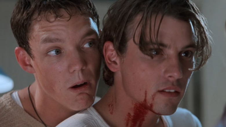 Stu with his chin on Billy's shoulder in Sidney's kitchen in Scream