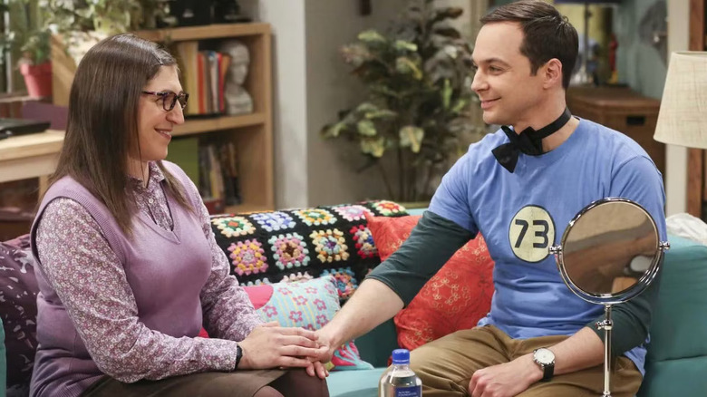 Sheldon wearing a bow tie holding hands with Amy on The Big Bang Theory