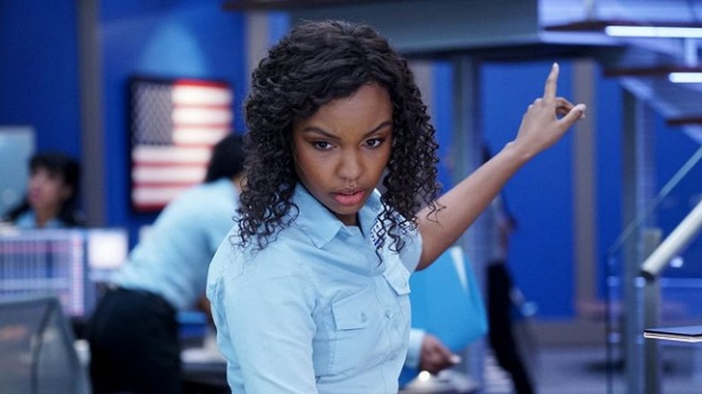 Sierra McClain as Grace Ryder standing at her desk and pointing in 9-1-1: Lone Star