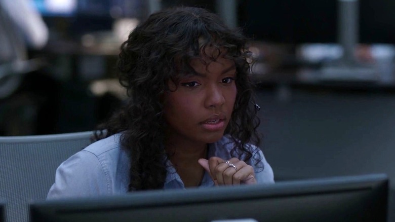 Sierra McClain as Grace Ryder sitting at her computer in 9-1-1: Lone Star