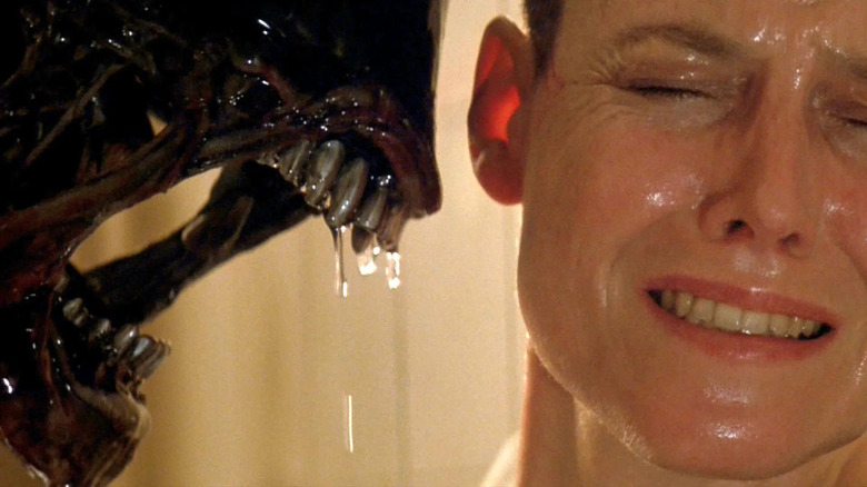 Ripley with a Xenomorph hissing next to her face in "Alien 3"