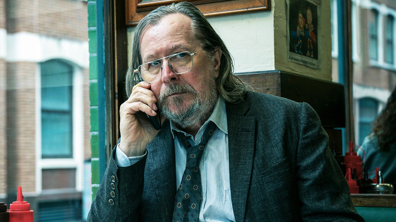 Gary Oldman's Jackson Lamb talks on the phone while sat in a diner in Slow Horses