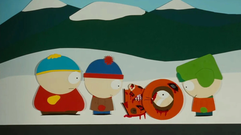 Kenny, mati, dengan Cartman, Stan, dan Kyle menatapnya di South Park