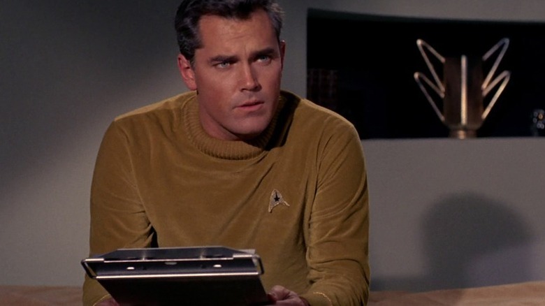 Pike holding a clipboard on Star Trek