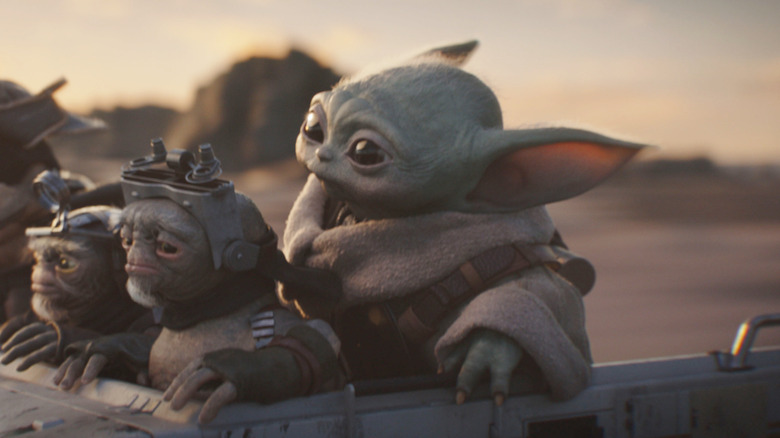 Grogu and a trio of Anzellans flying on a speeder in The Mandalorian and Grogu