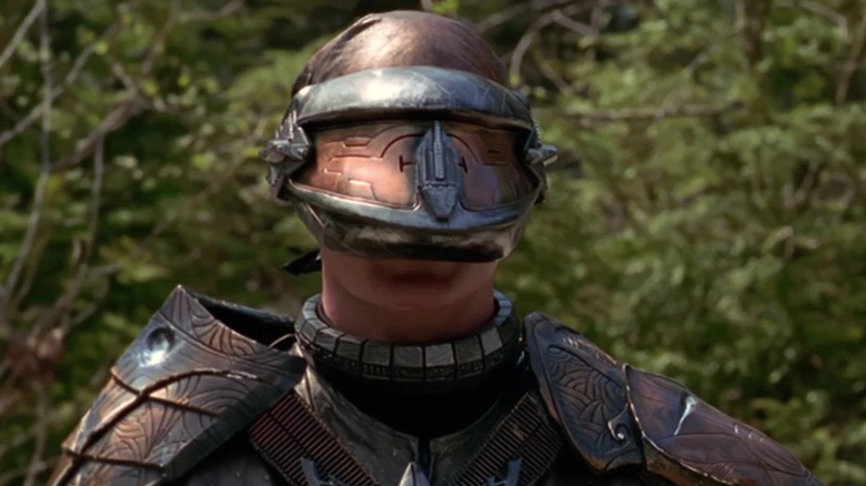 Sam J. Jones' Aris Boch wearing armor and a helmet on Stargate SG-1